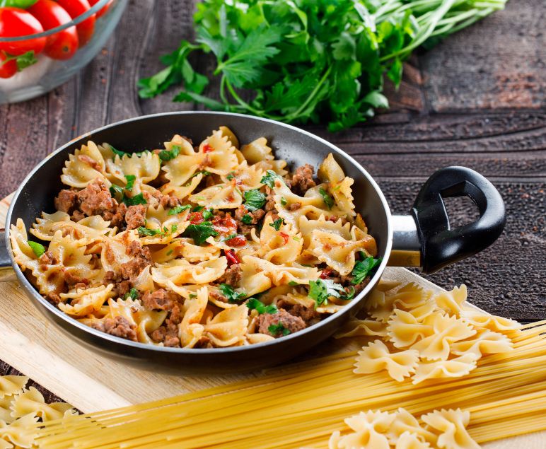 A delicious bowl of Creamy Chicken and Chorizo Pasta garnished with herbs